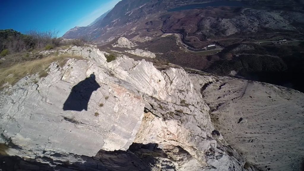 wingsuit shadow at cliff